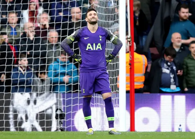 Lloris holds hands up after Reds error