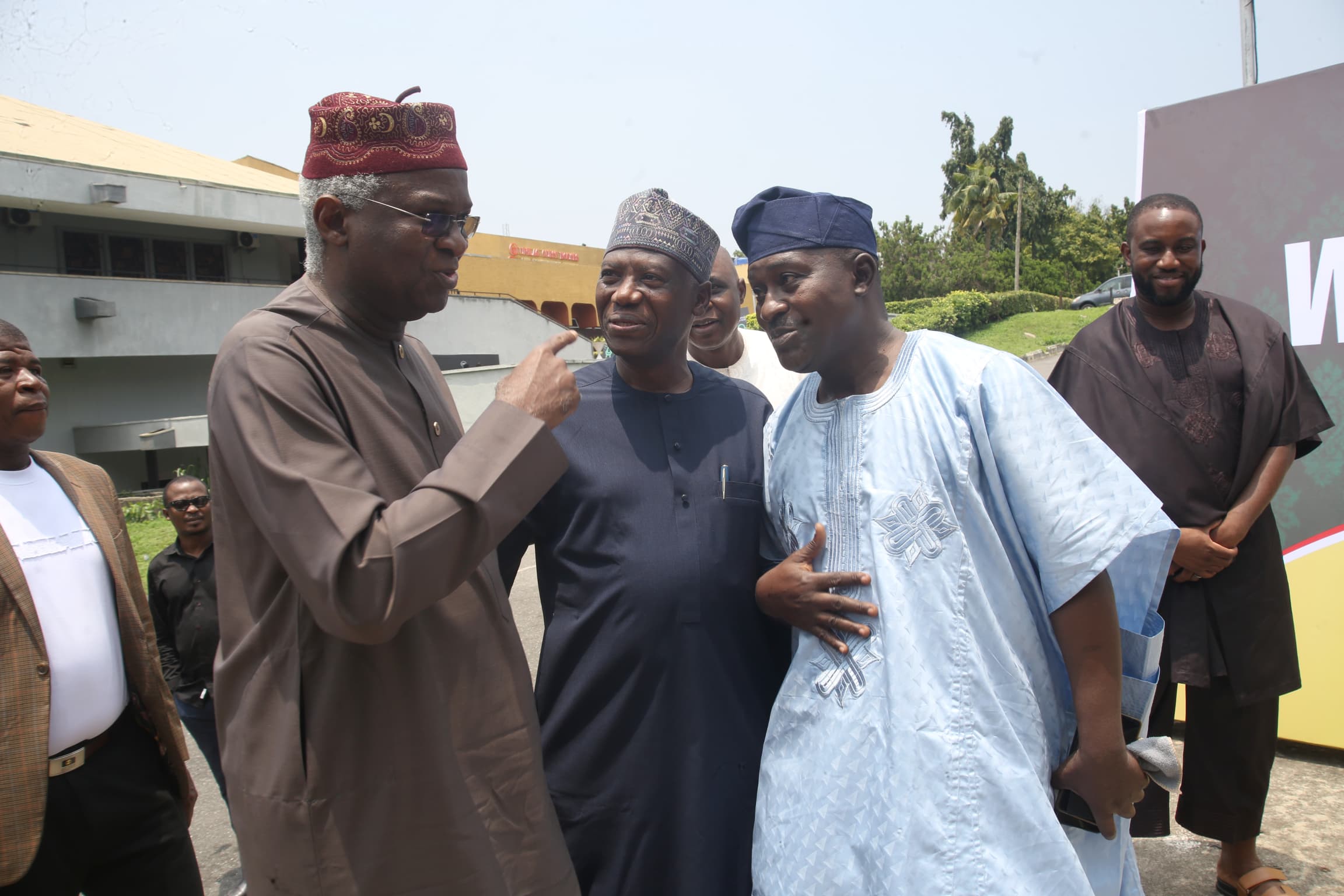 Dr. Mumini Alao (m) and Mr. Abdulfatai Abdulsalam – his old school mate and the event Chief Organiser, welcome His Excellency, Babatunde Raji Fashola (SAN) to the venue of Alao's Autobiography public presentation.