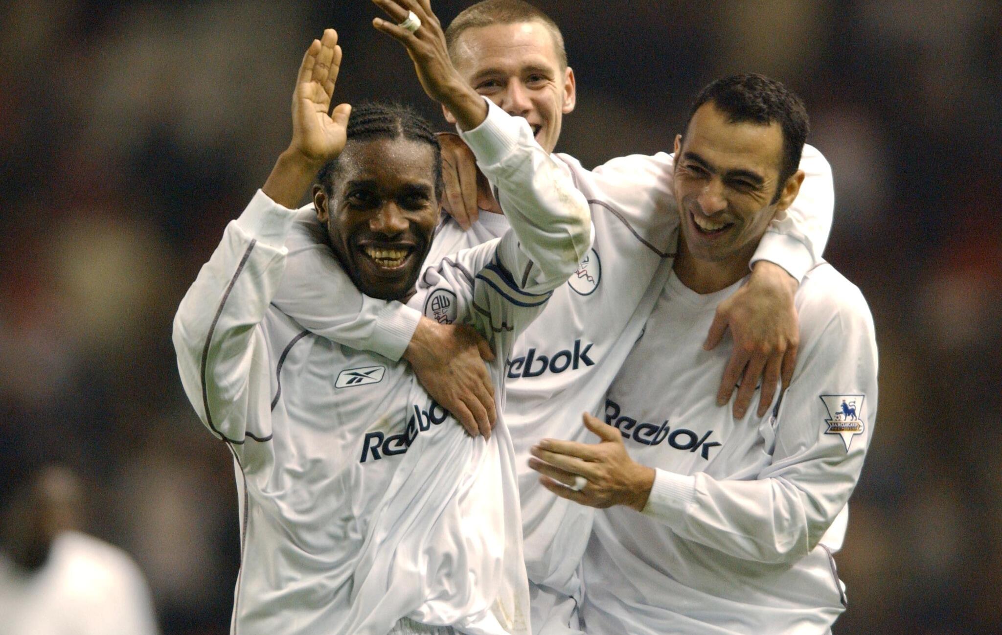 Jay Jay Okocha celebrates a goal for Bolton Wanderers with teammates 