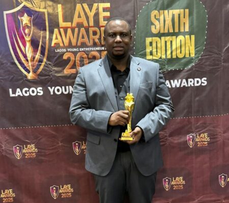 Dr. Solomon Ojeagbase with his Outstanding Sports Business Entrepreneur Award received at LAYE Awards 2025